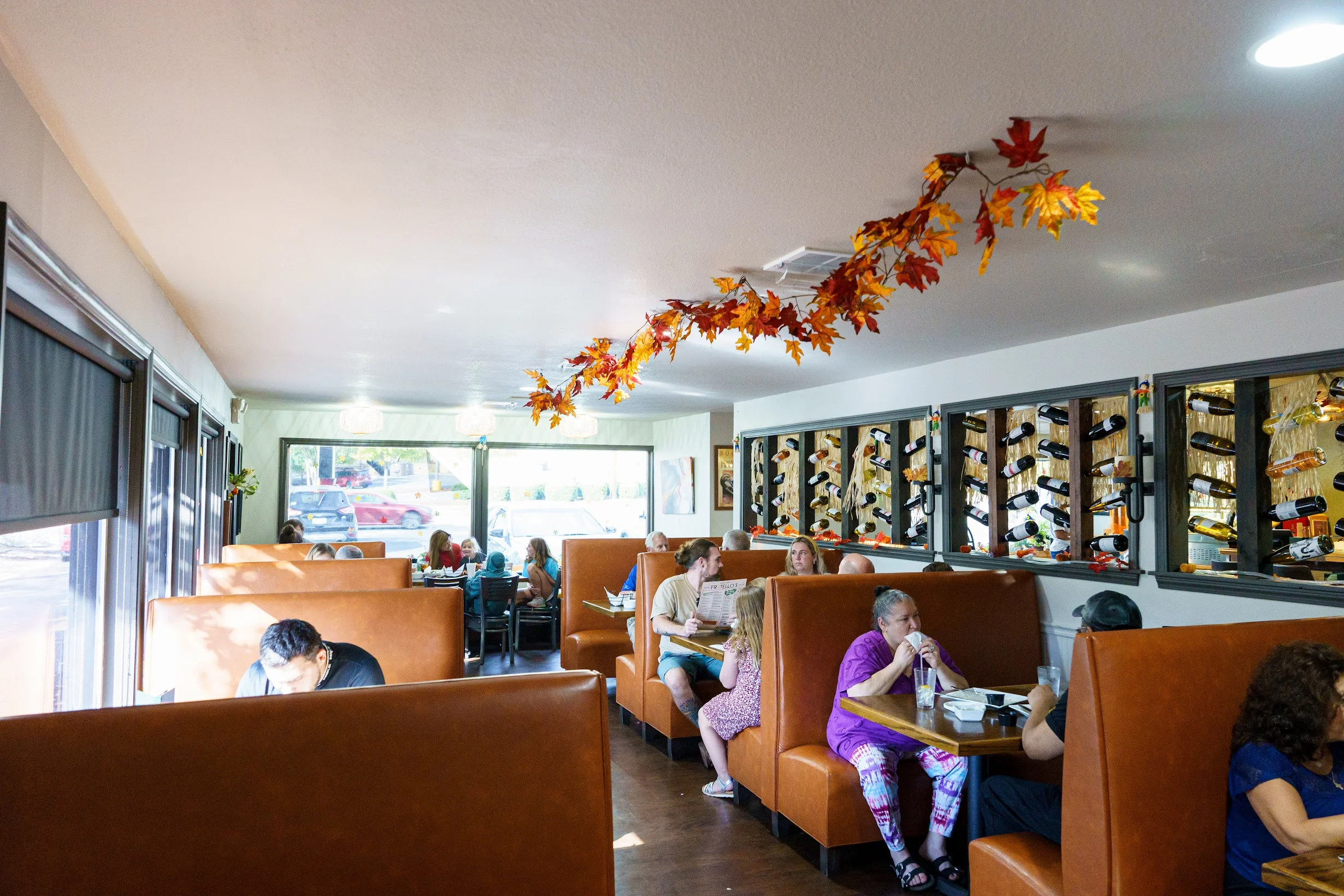 Cozy restaurant seating area with wooden tables and comfortable chairs.