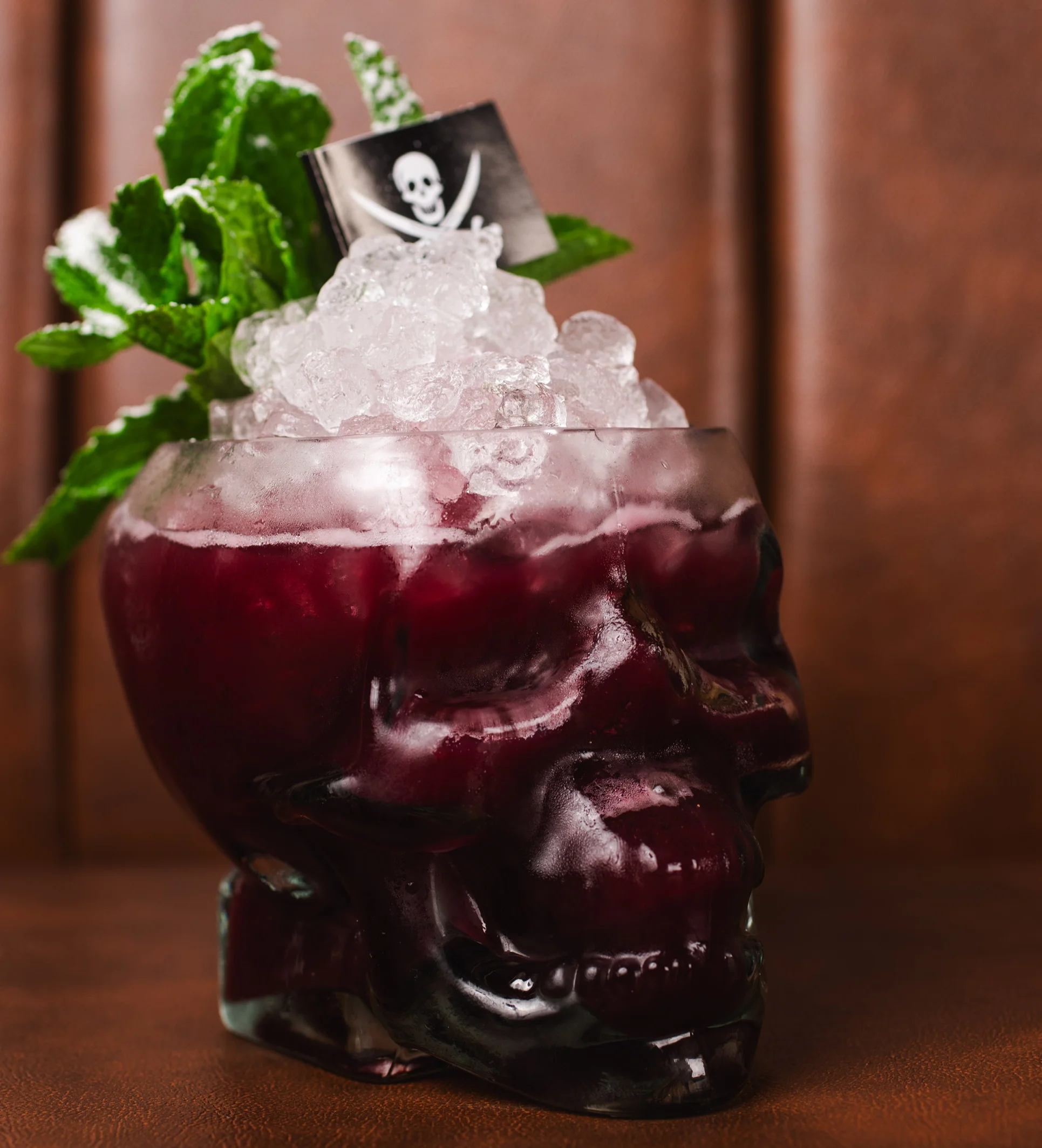 Bartender preparing a refreshing cocktail with fresh mint leaves