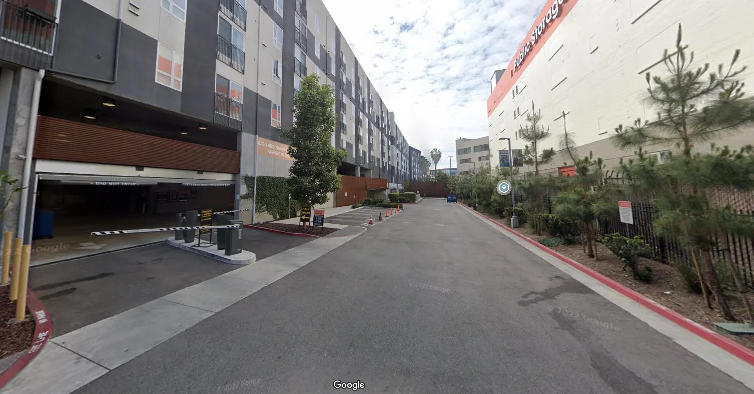 Urban street view with modern buildings and parking entrance