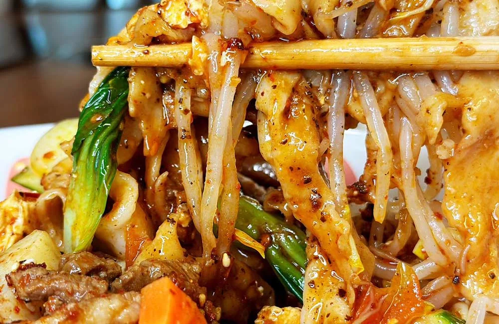 Spicy Sichuan noodles with vegetables and sesame sauce