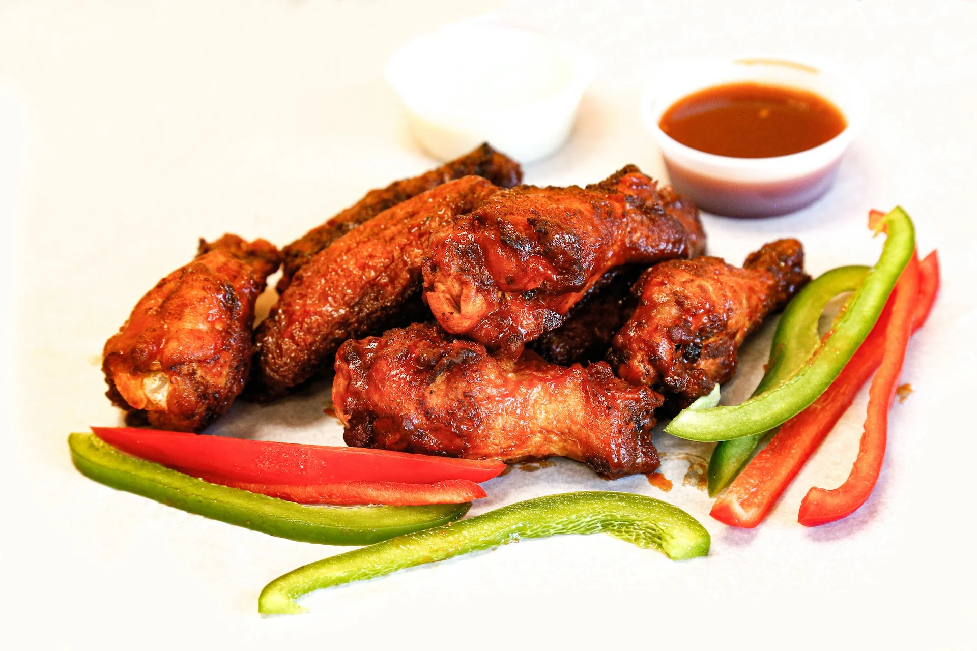 Chicken wings with sauce and peppers