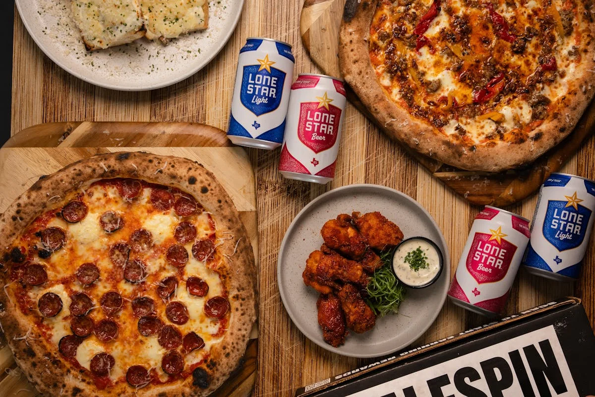 Pepperoni pizza and buffalo wings with craft beer