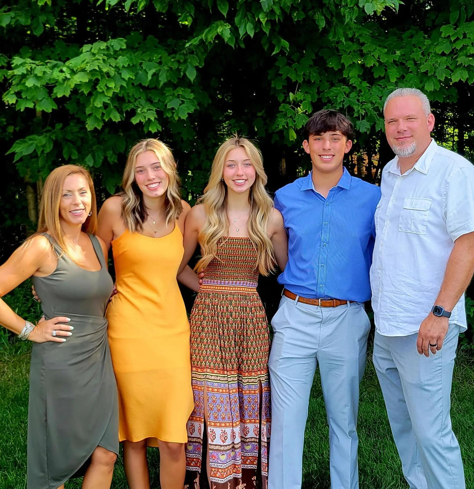 Family portrait in a lush green garden setting