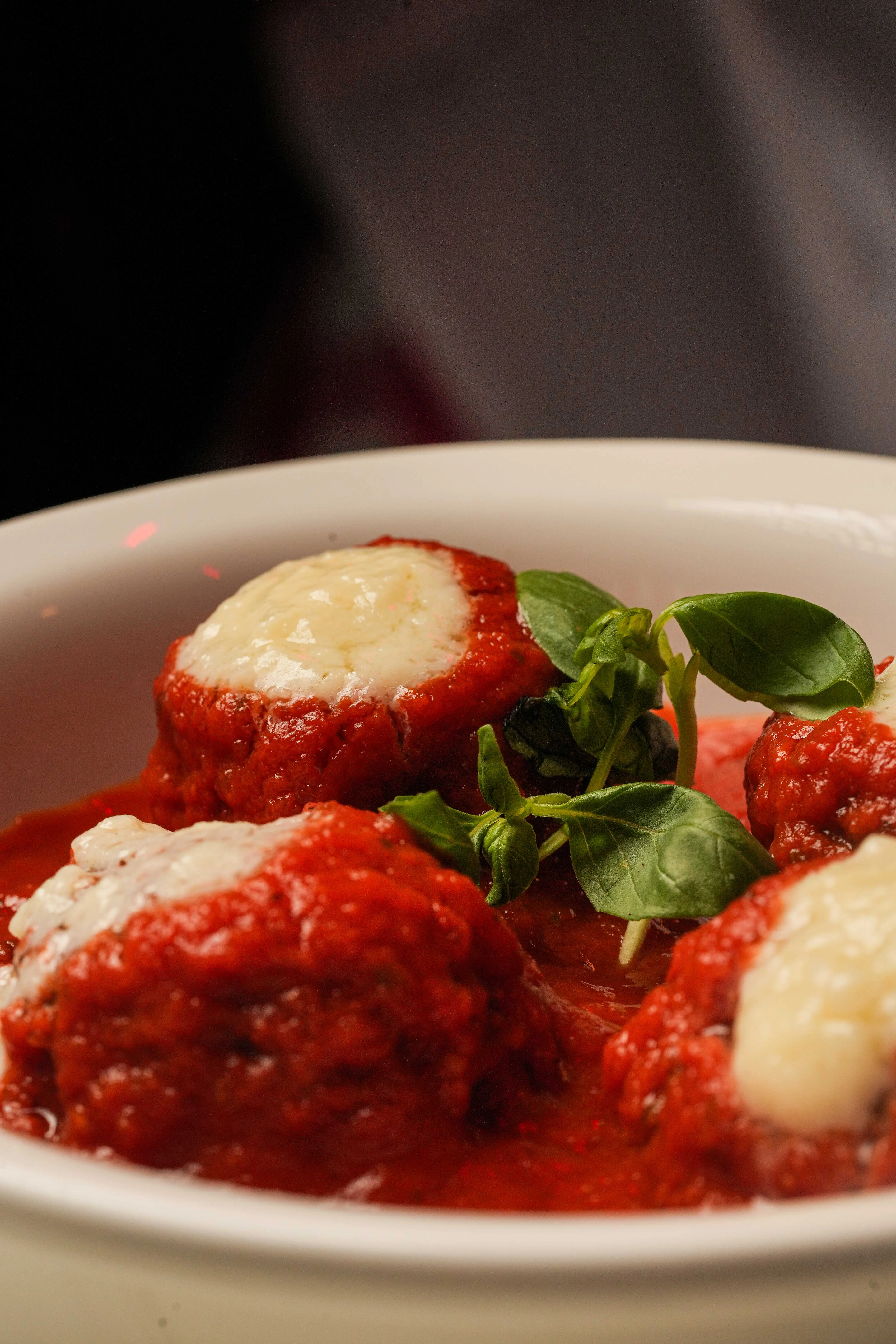 Italian meatballs in marinara sauce with fresh basil