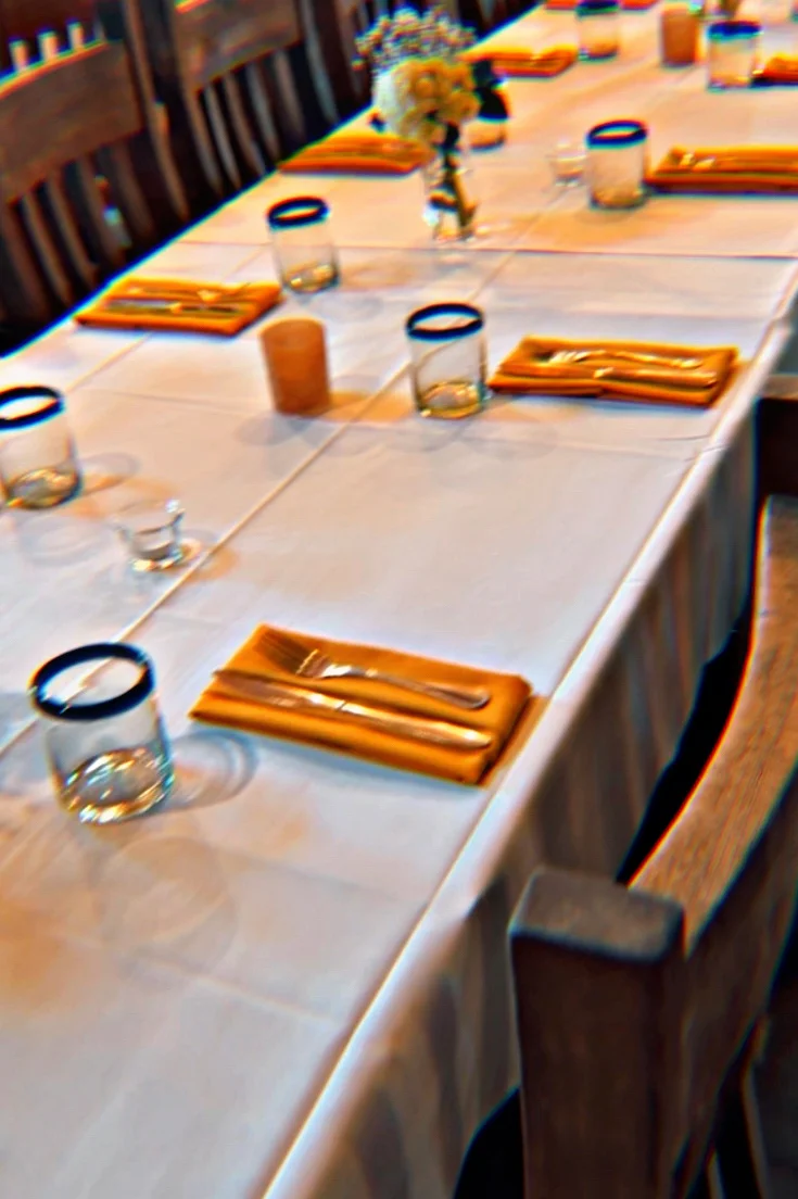 Elegant dining setup with wooden chairs and floral centerpieces