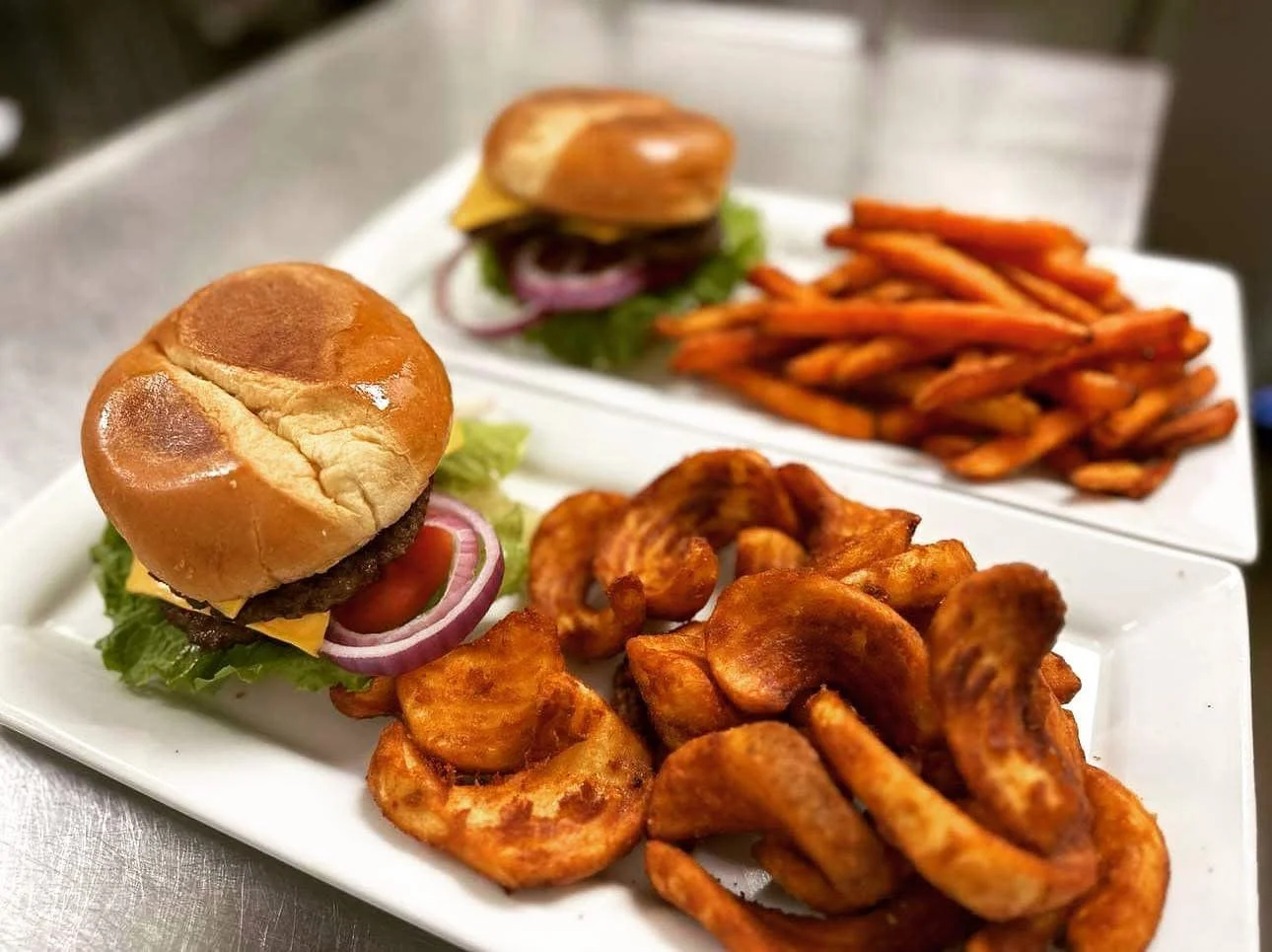 Classic American cheeseburger with curly fries