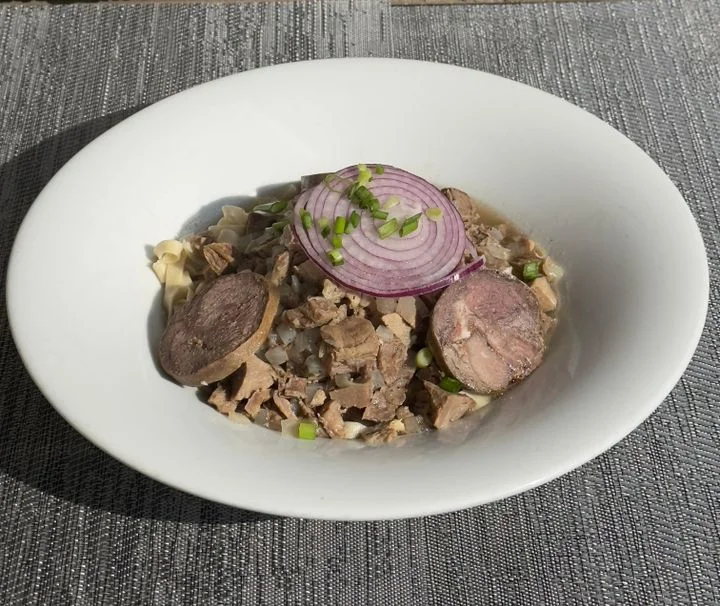 Traditional Mexican birria served in a bowl with onions