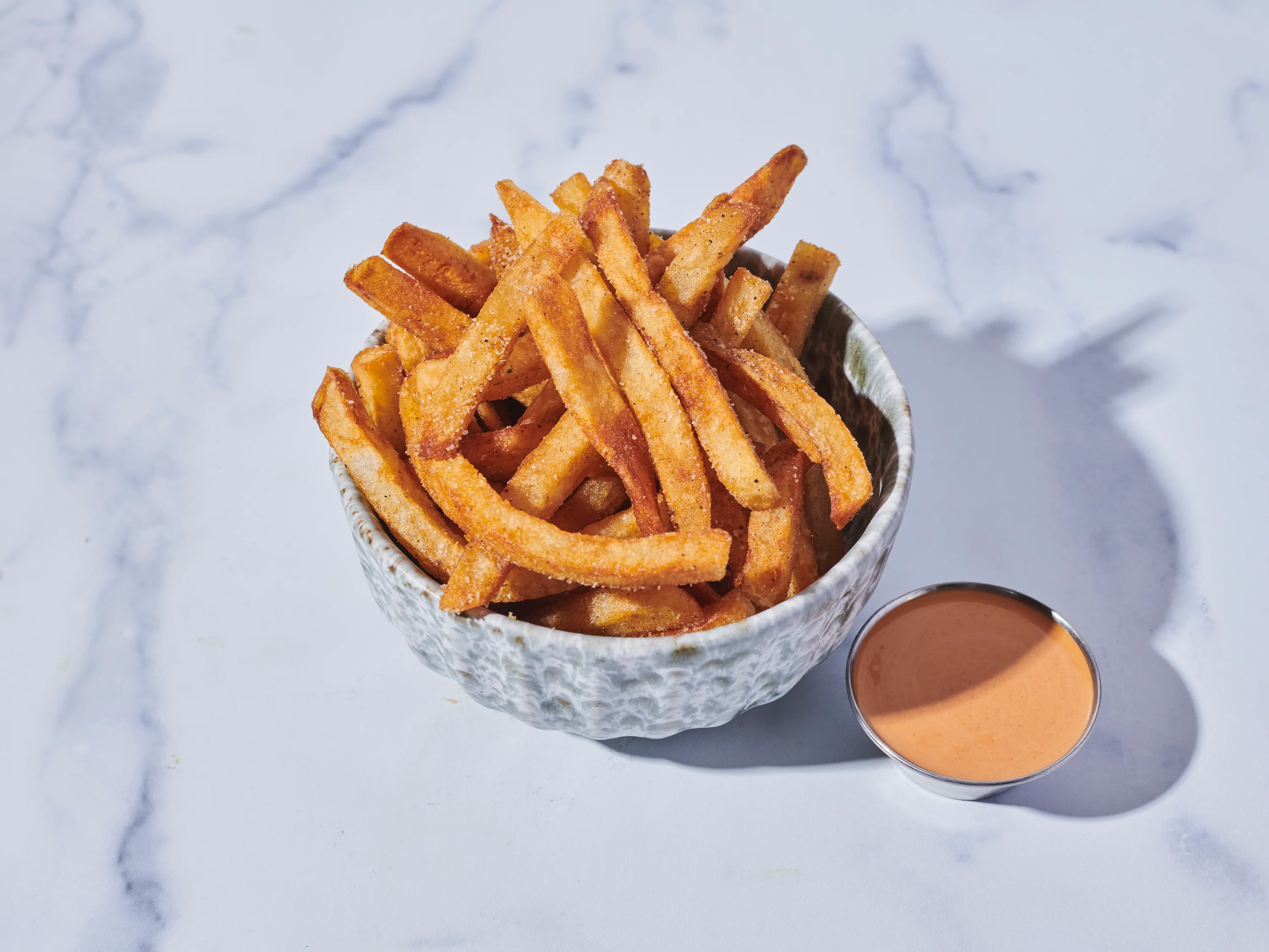 Crispy French fries served with dipping sauce
