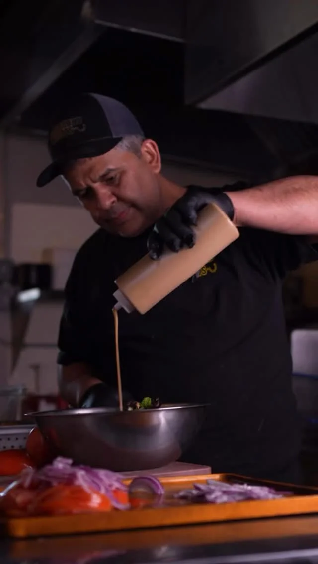 Chef preparing a fresh salad in a vibrant kitchen