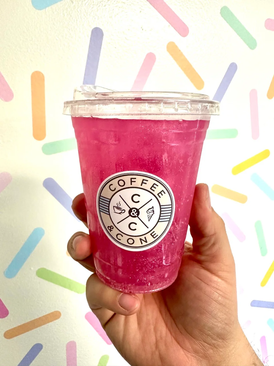 Vibrant pink beverage in a clear cup from Coffee & Cone