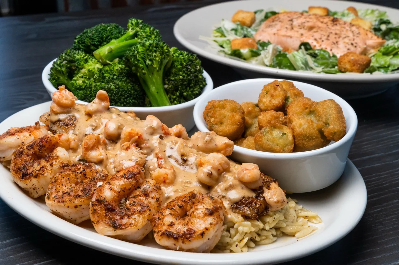 Hot off the Grill! Grilled Catfish and Shrimp smothered in our crawfish cream sauce with the best sides- fresh broccoli, fried okra