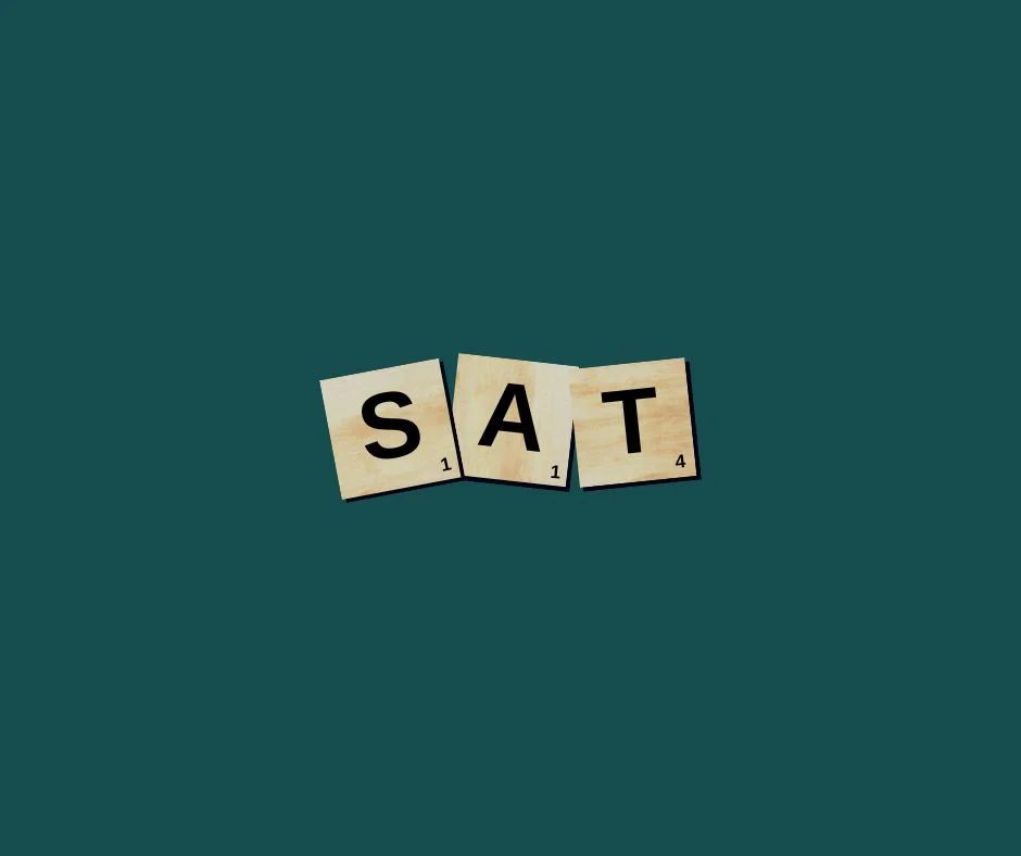 Scrabble tiles spelling 'SAT' on a green background