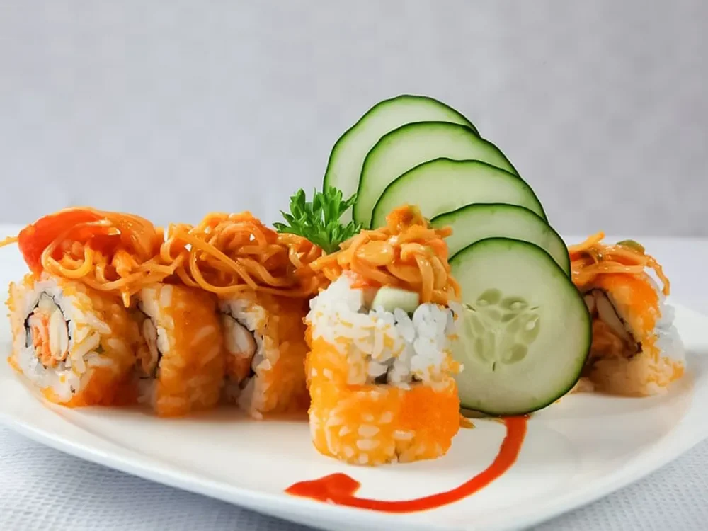 Japanese sushi rolls with cucumber and spicy sauce presentation