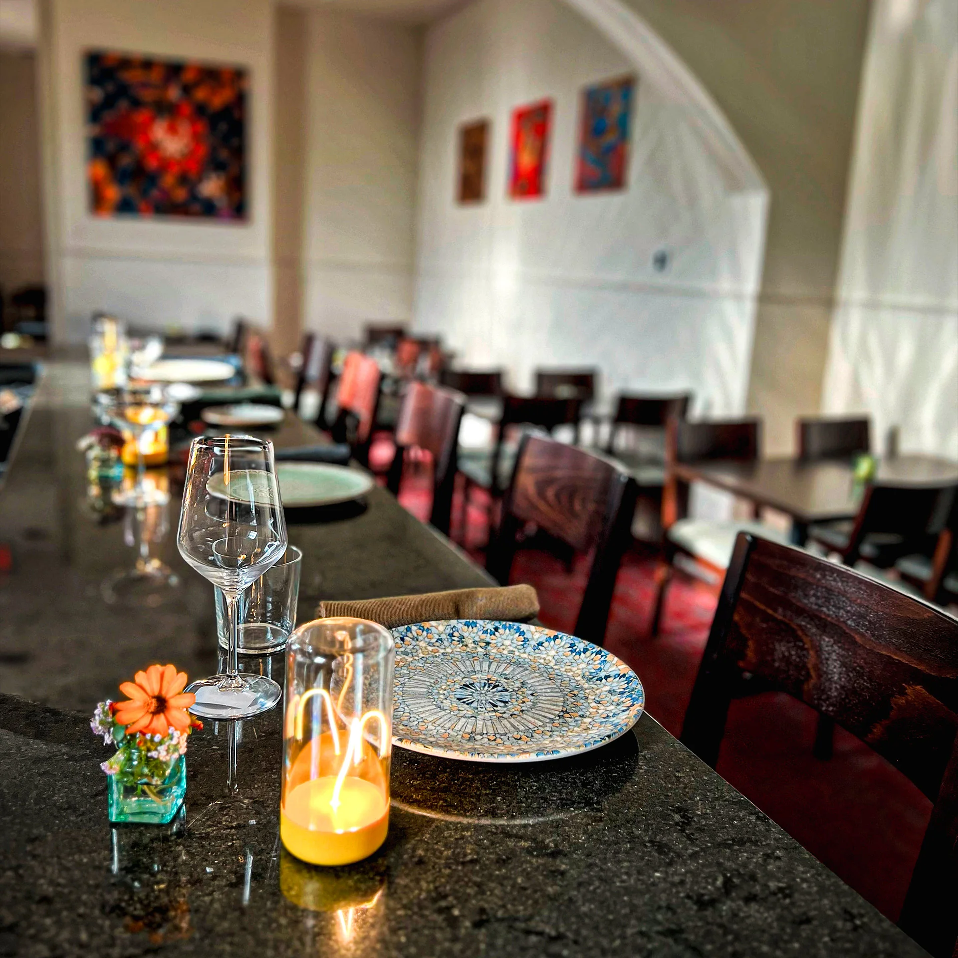 Elegant restaurant interior with tables, glassware, and decorative elements