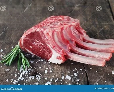 A beautifully plated rack of lamb with herbs and garnishes.