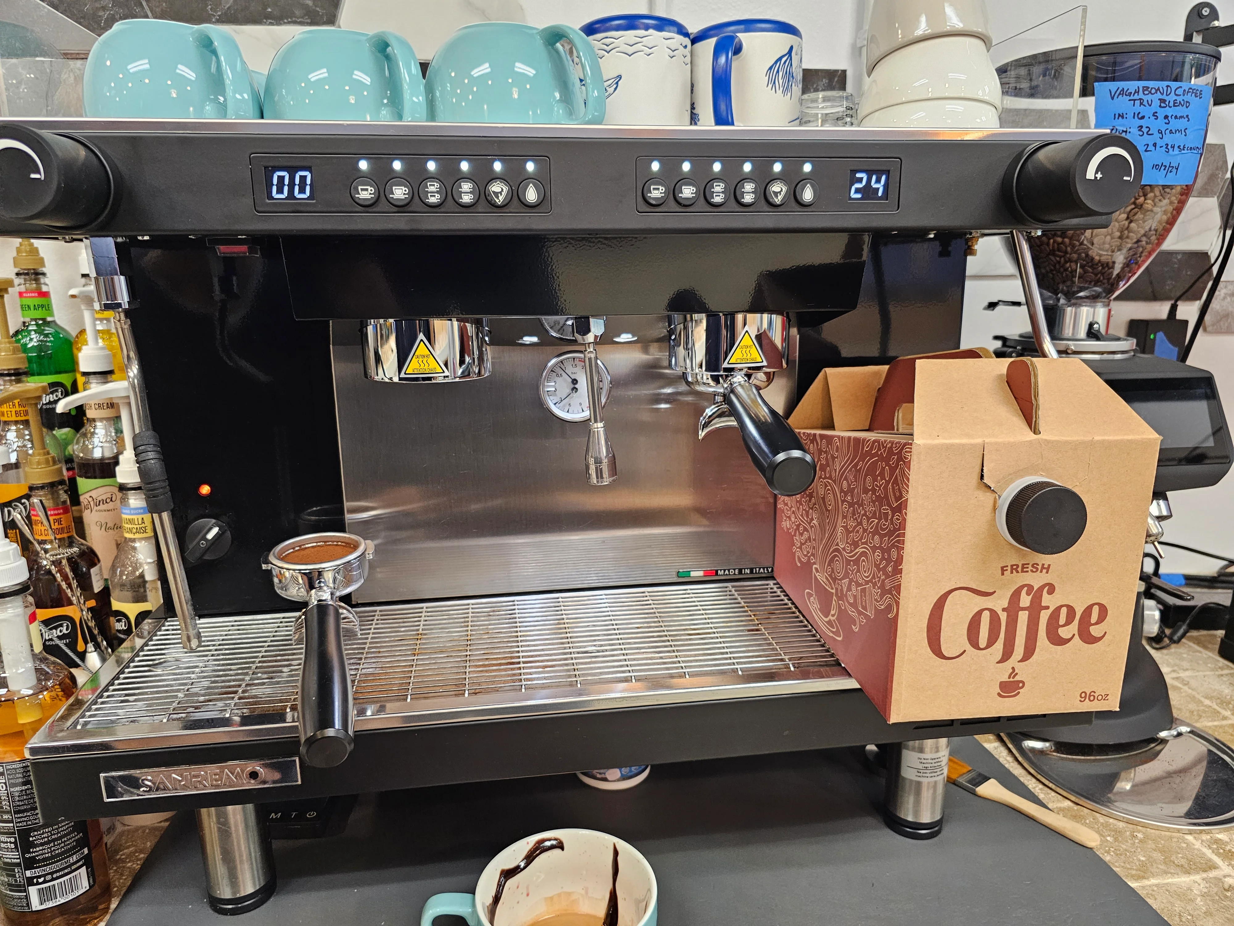 Espresso machine with fresh coffee box at a café