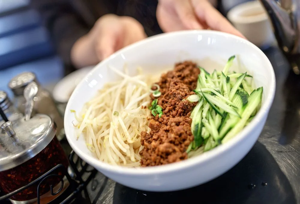 Bowl of Chinese dan dan noodles with toppings