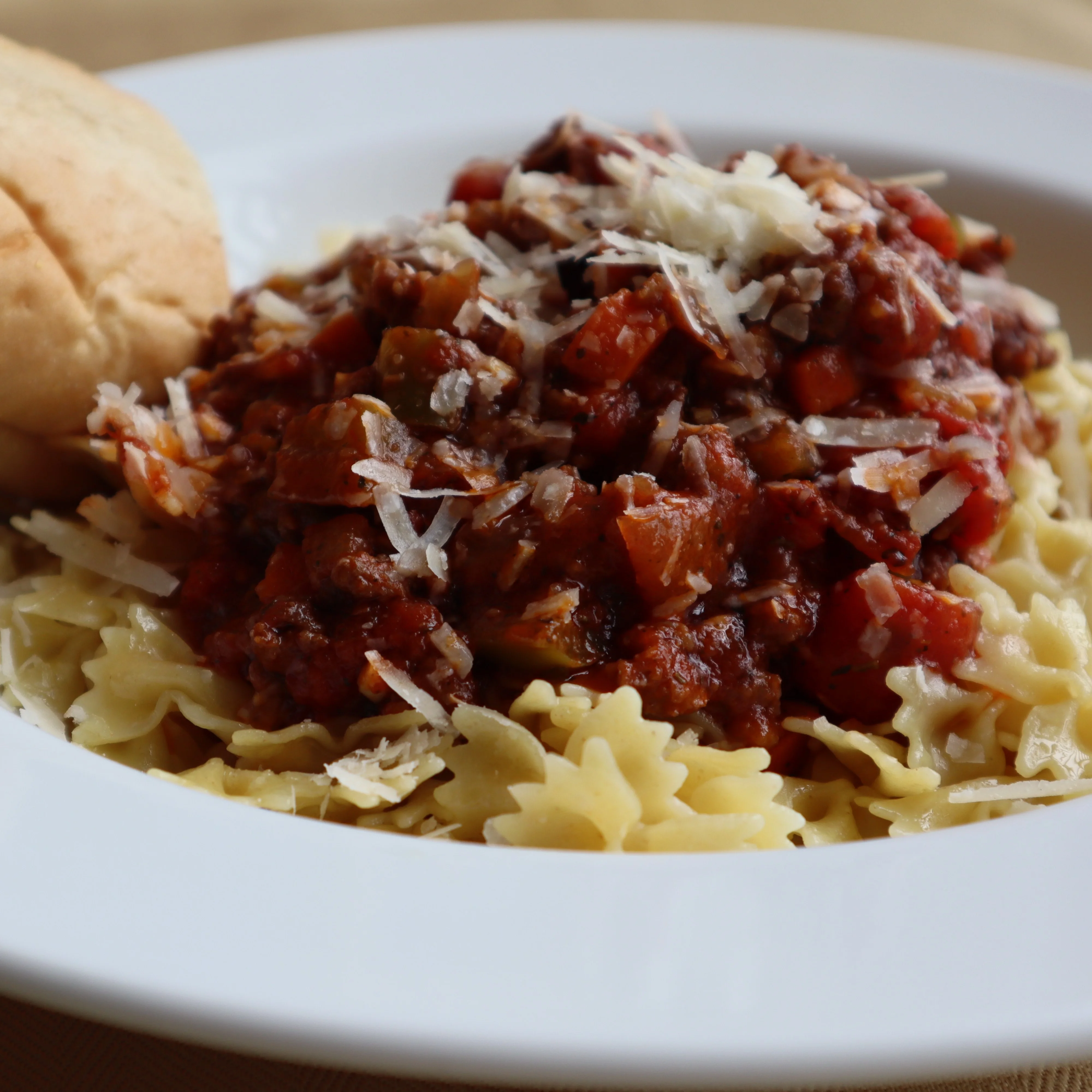 Hearty Italian pasta with meat sauce and parmesan