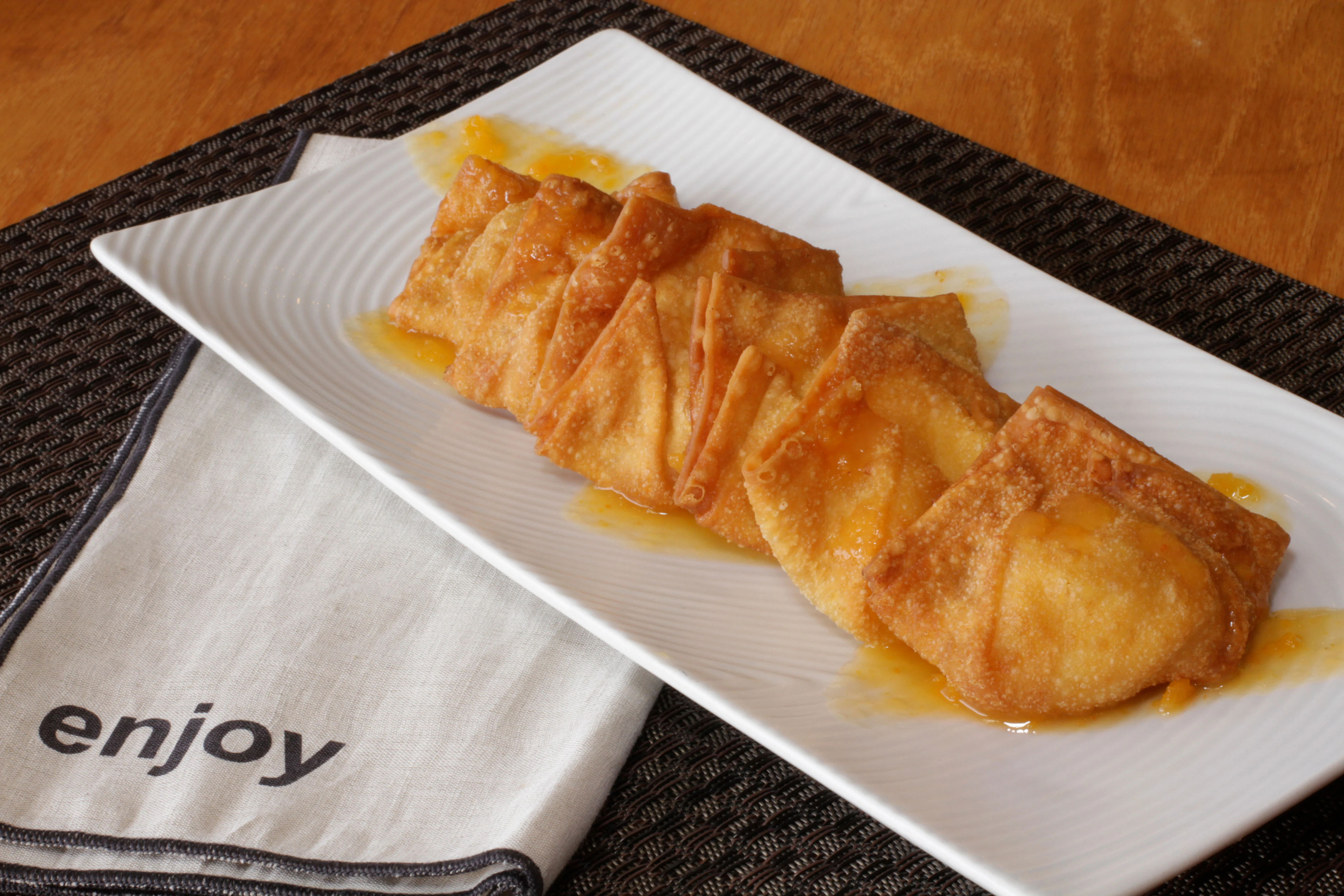 Crispy Chinese wontons drizzled with sweet sauce