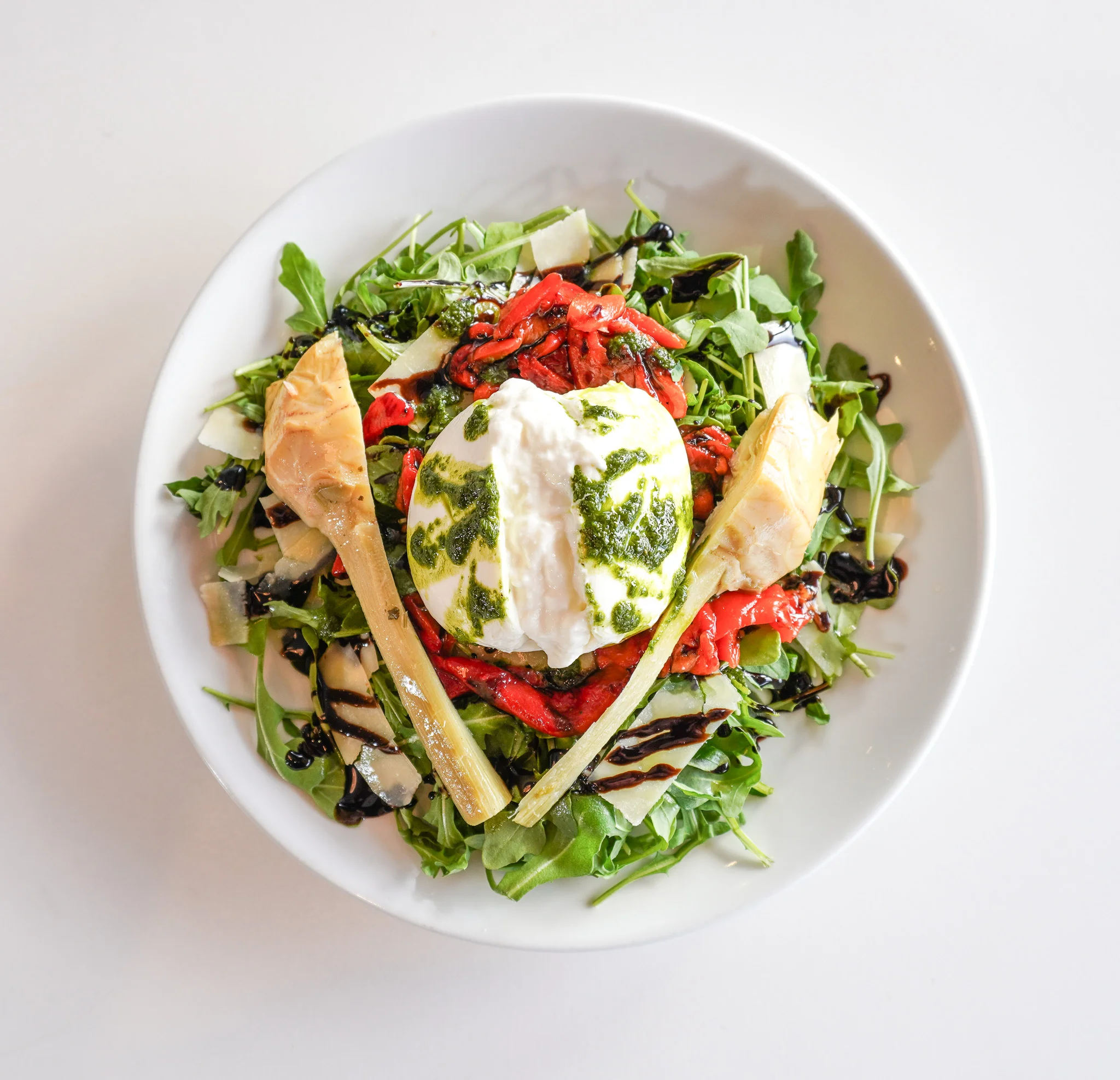 Italian burrata salad with arugula and roasted peppers