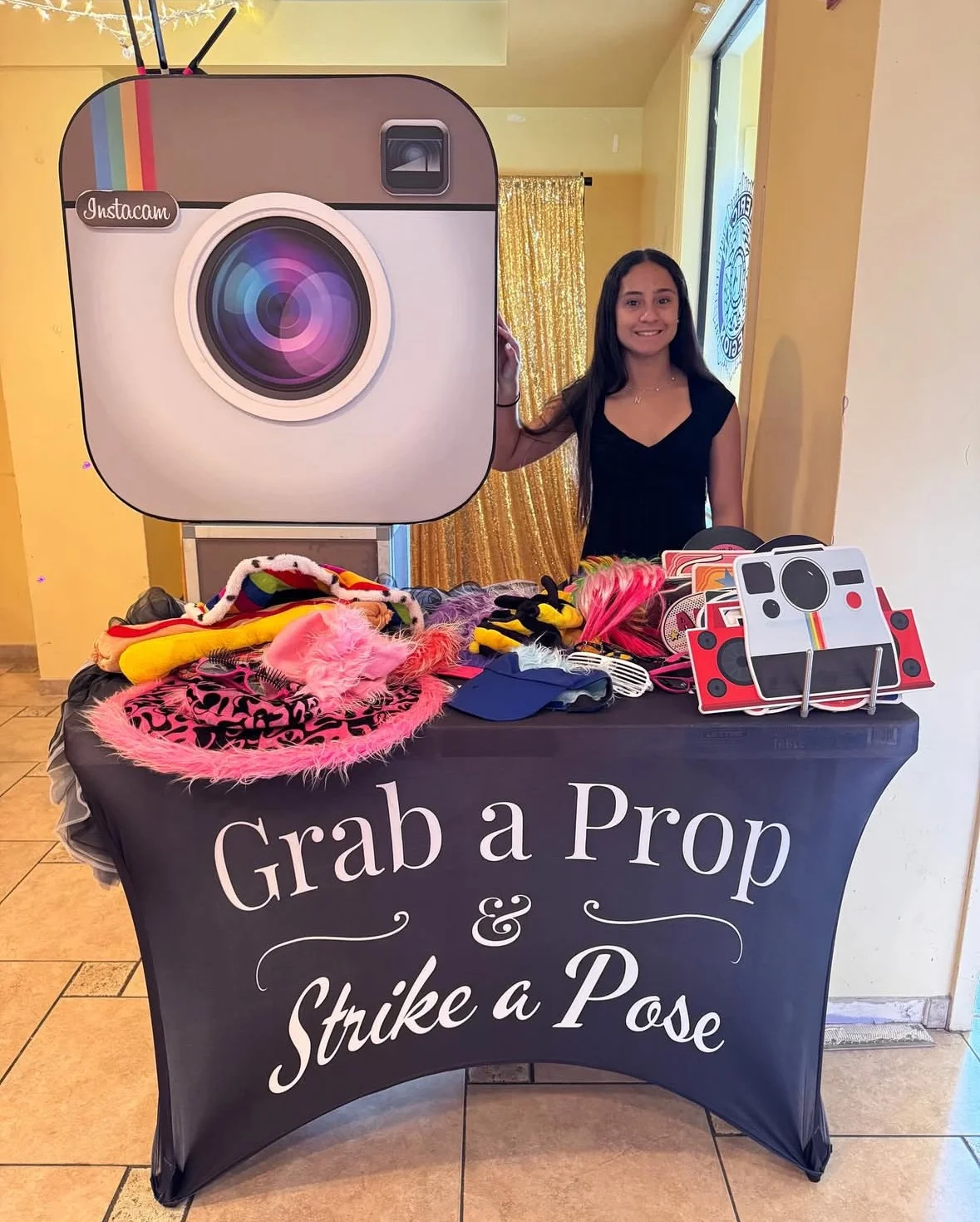 A fun photo booth setup with a large Instagram logo and various props for guests to use.
