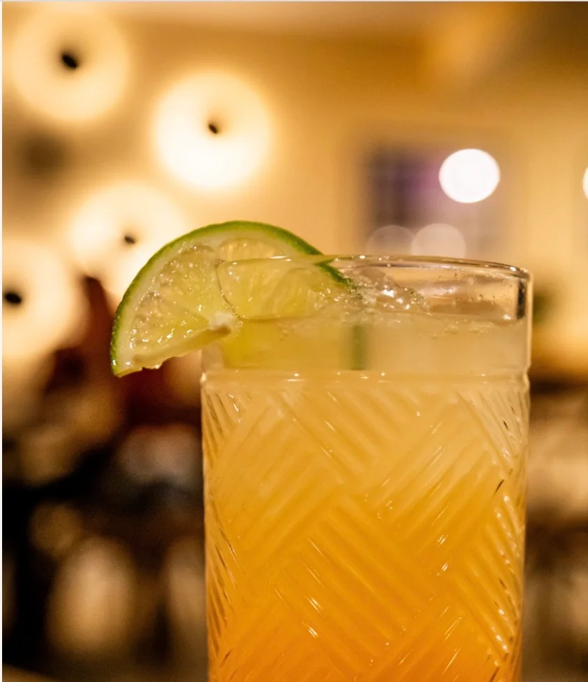 Refreshing cocktail with lime garnish in a stylish glass