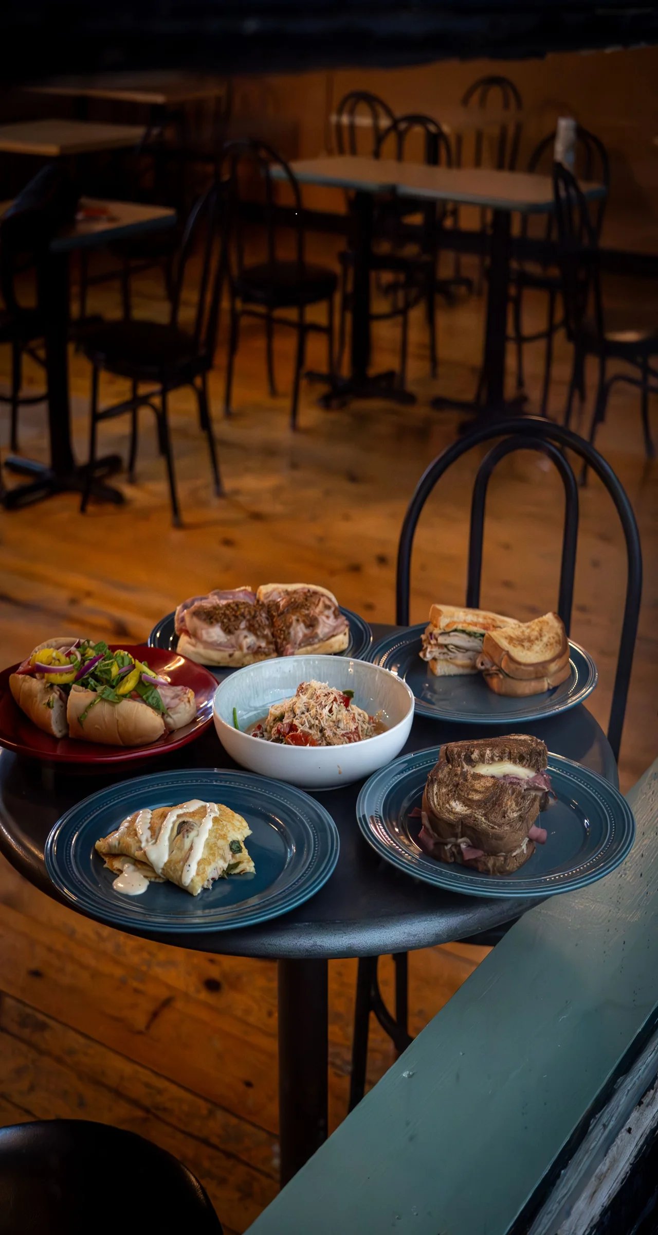 Assorted sandwiches and salads on a restaurant table