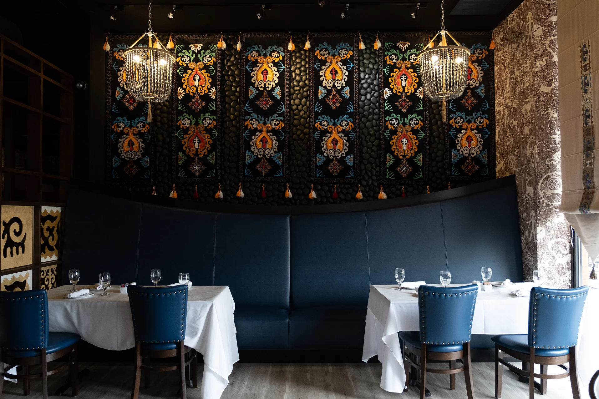 Elegant restaurant interior with colorful wall art and cozy seating