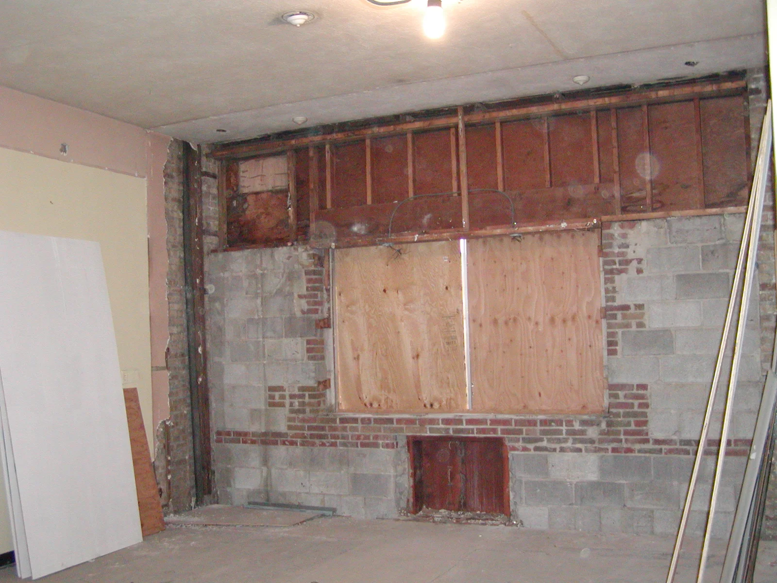 Renovation progress of a restaurant interior with exposed brick and wooden framing