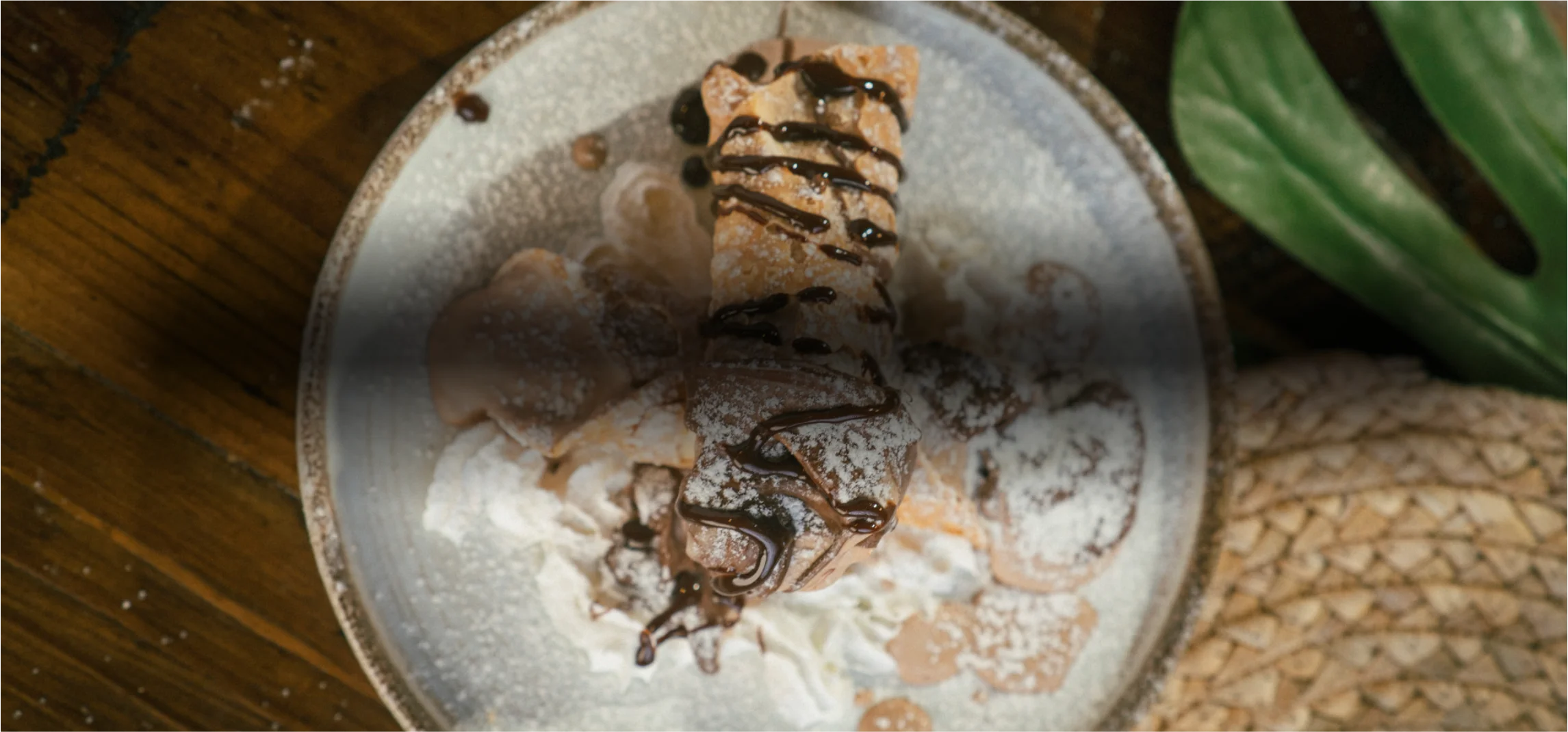 Italian cannoli drizzled with chocolate sauce and powdered sugar
