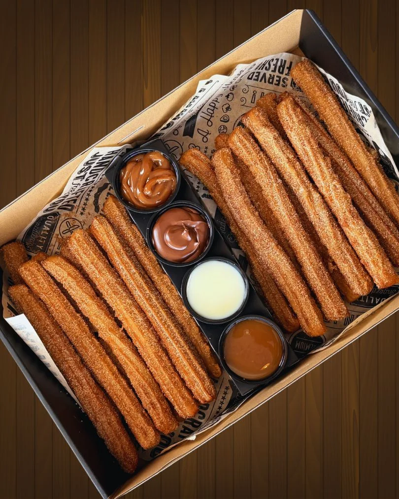 Delicious churros served with assorted dipping sauces