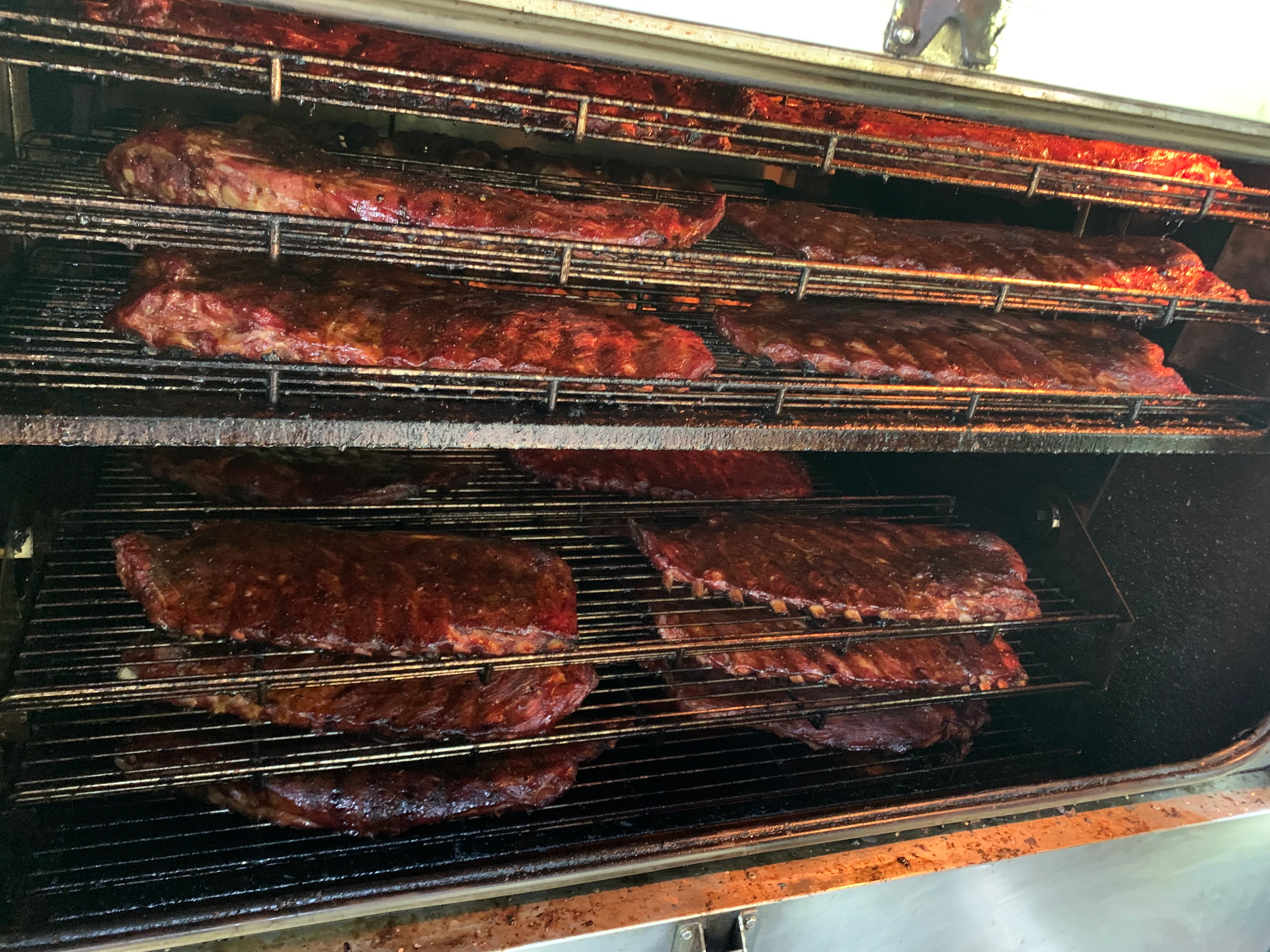 Smoked barbecue ribs in a commercial smoker