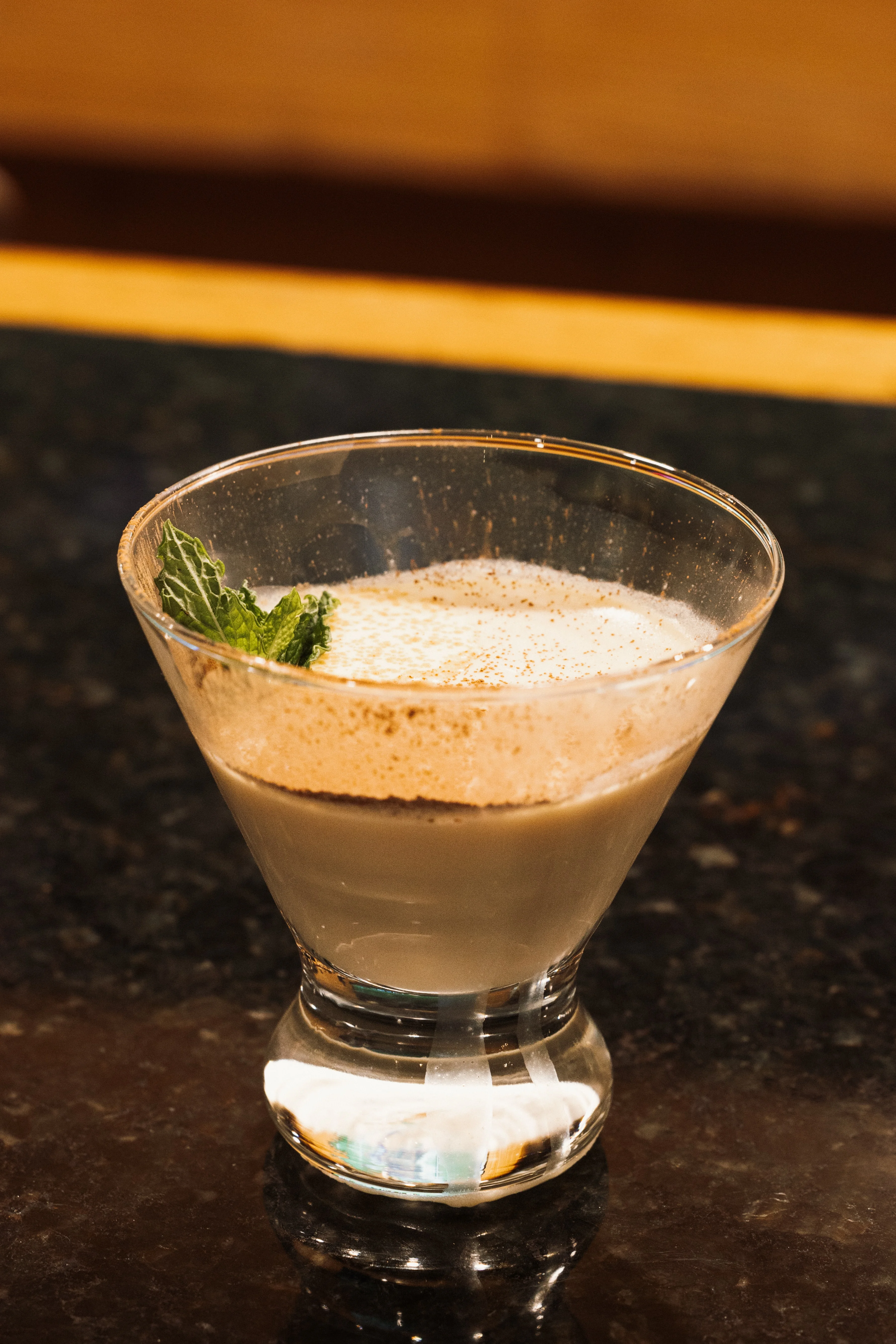 Creamy cocktail garnished with mint leaves