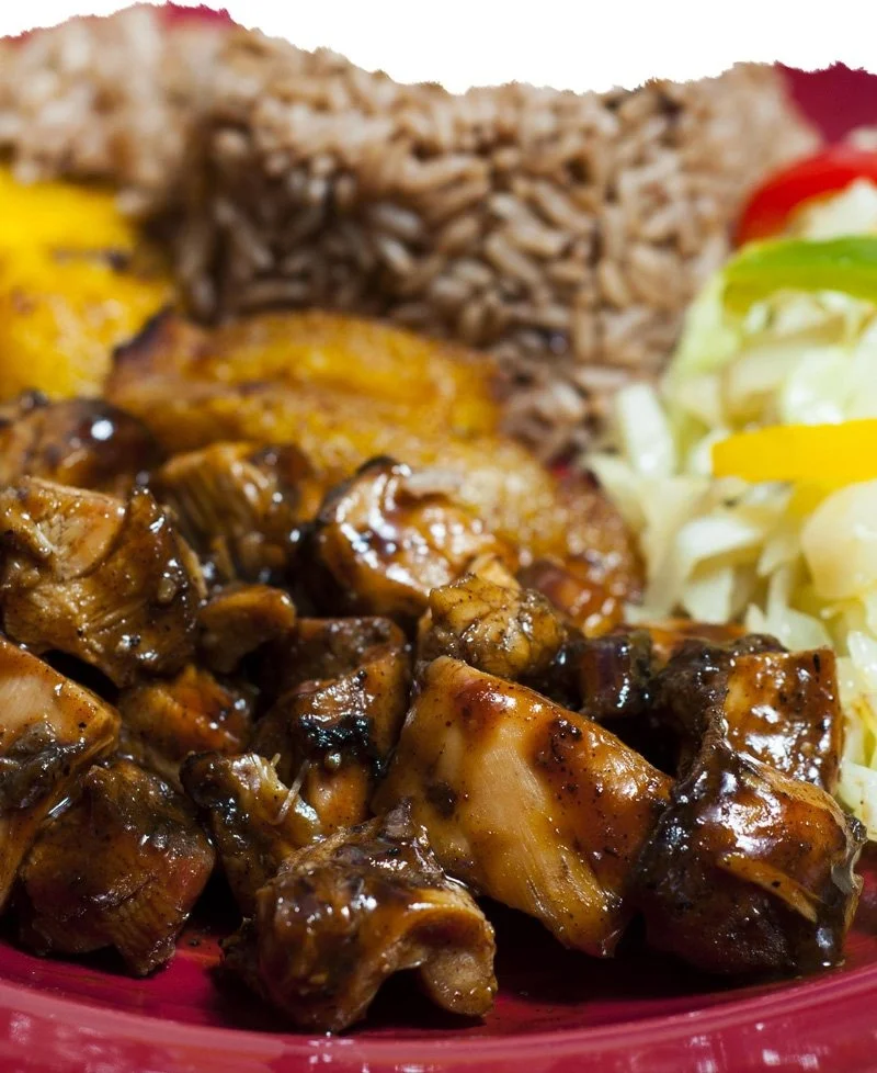 Jamaican jerk chicken served with rice and peas