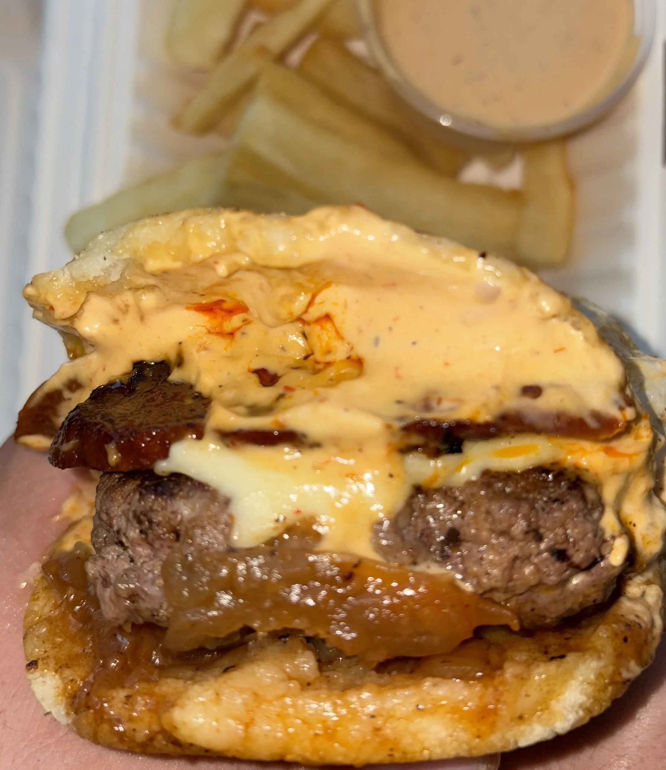 Juicy cheeseburger with spicy sauce and crispy fries