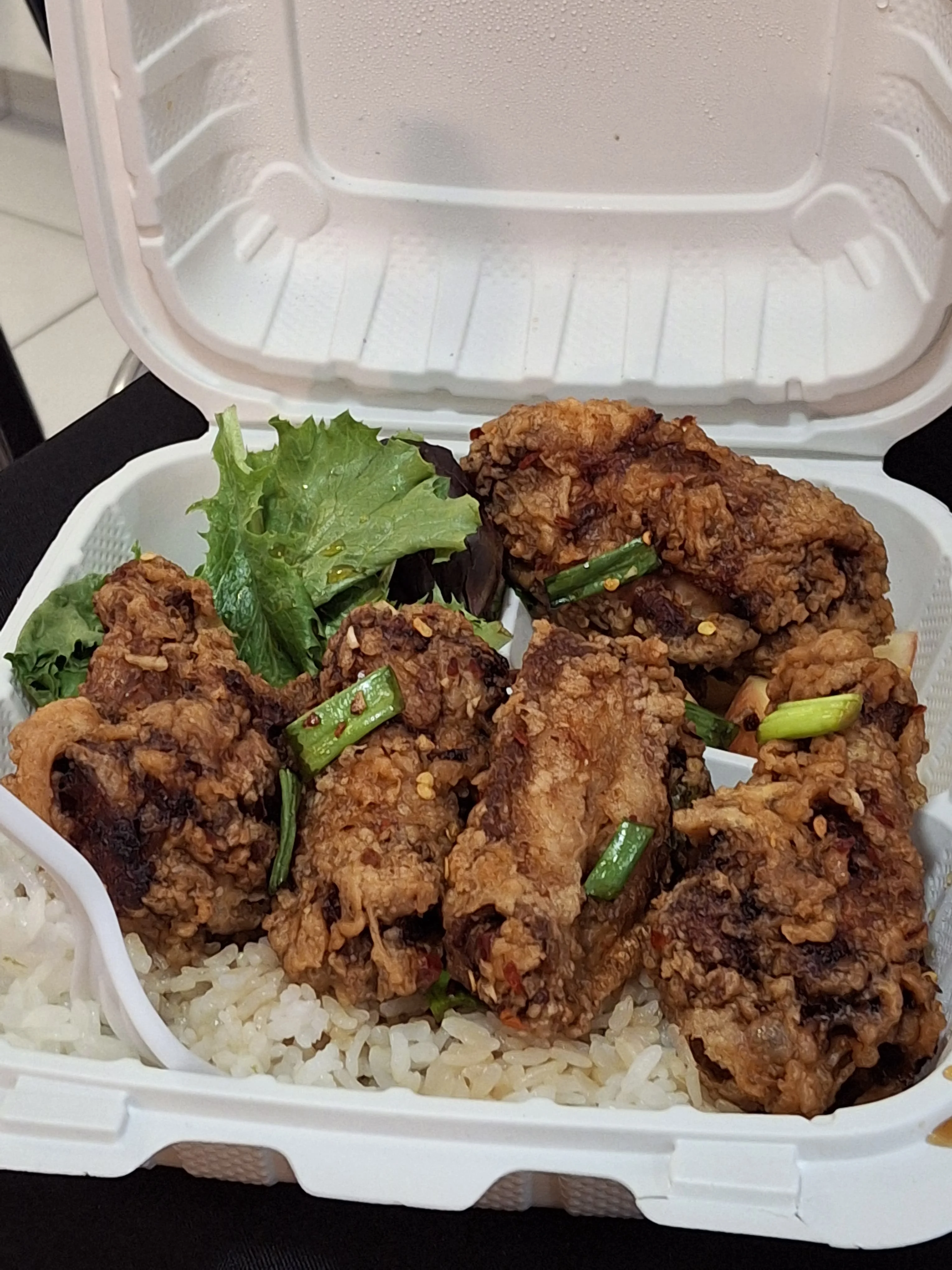 Crispy Korean fried chicken with rice and greens