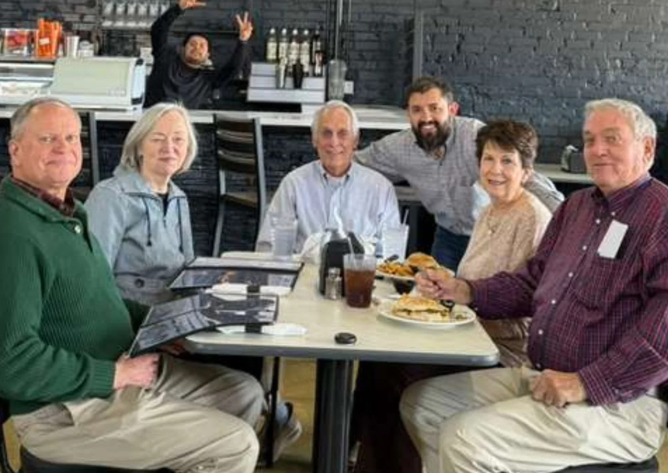 Group of friends enjoying a meal in a cozy restaurant setting
