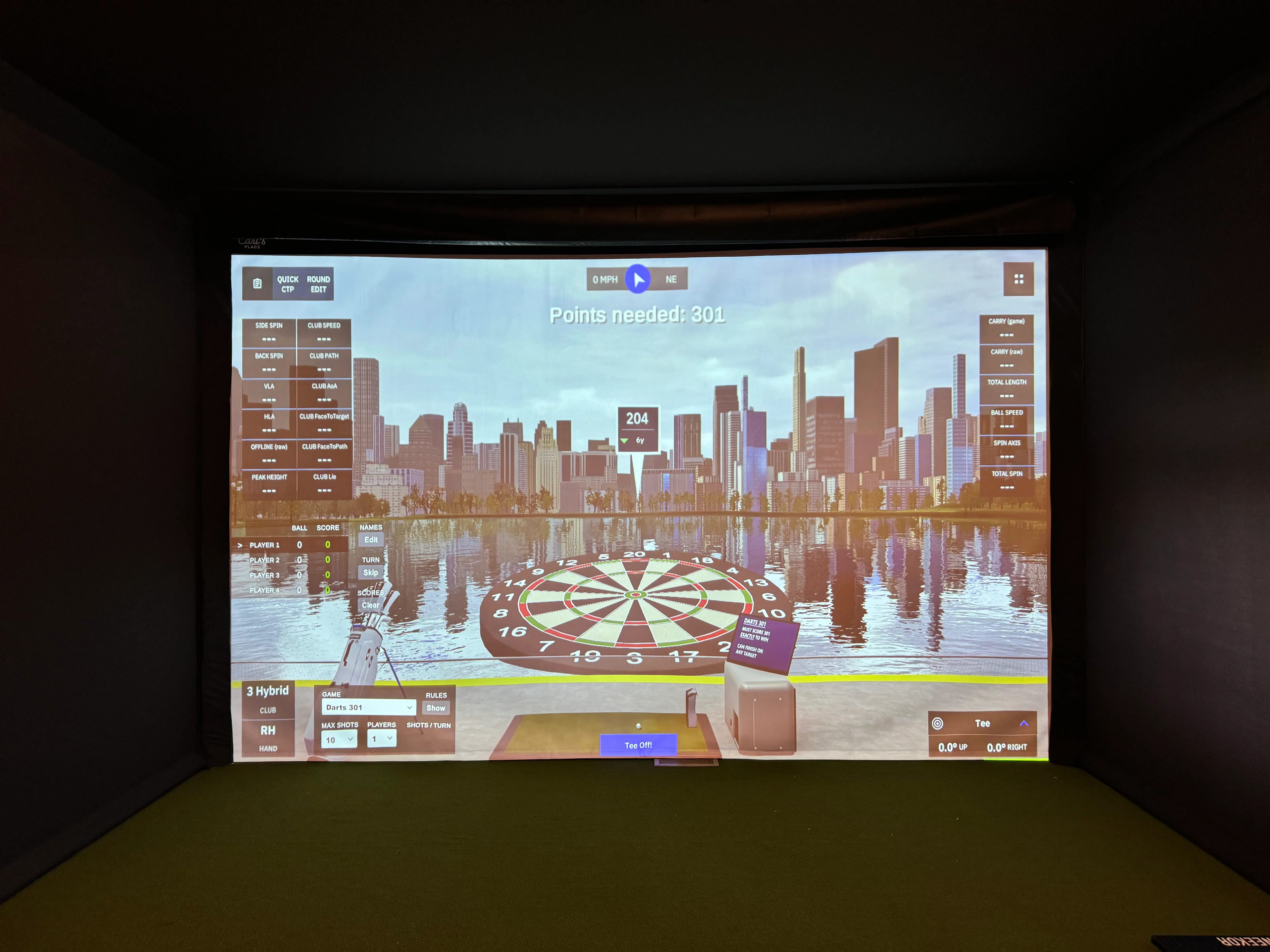 Interactive golf simulator with city skyline backdrop