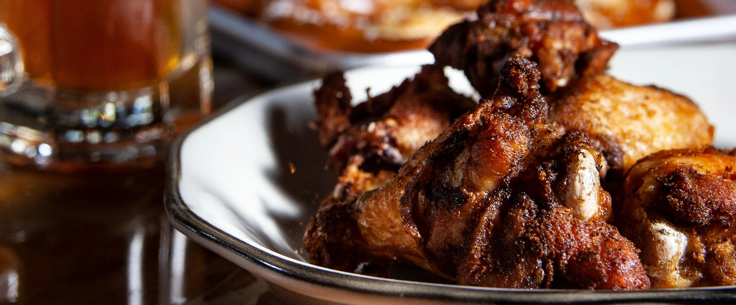 Crispy chicken wings with a cold beer in a cozy pub setting