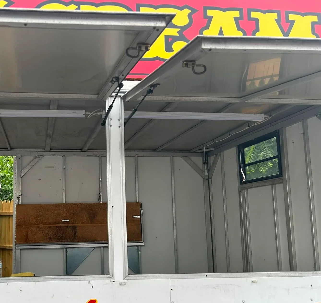 Ice cream stand with open windows and bright signage