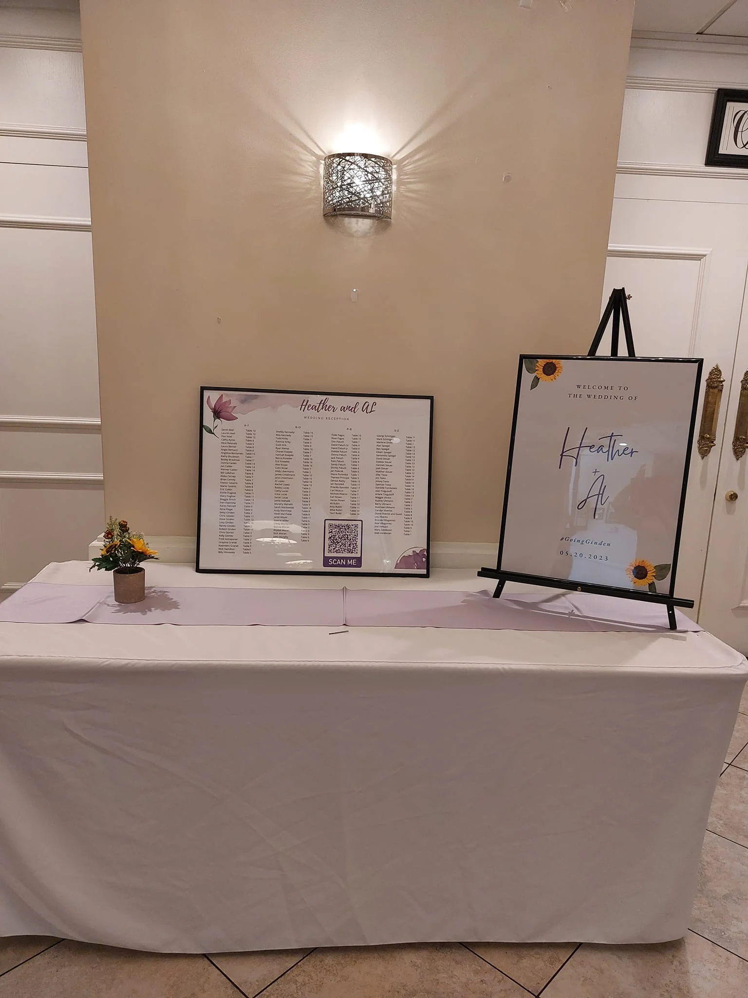 Wedding welcome display with floral decor and seating chart