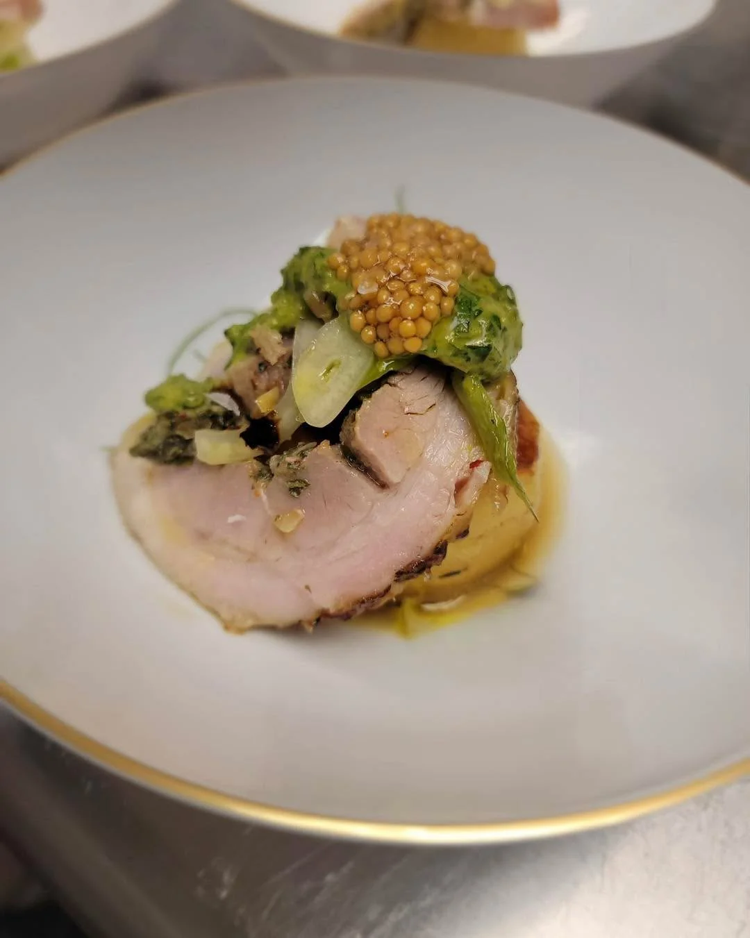 Sliced pork belly with mustard greens and sauce