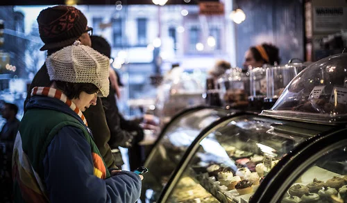 Customers ordering desserts at a cozy café