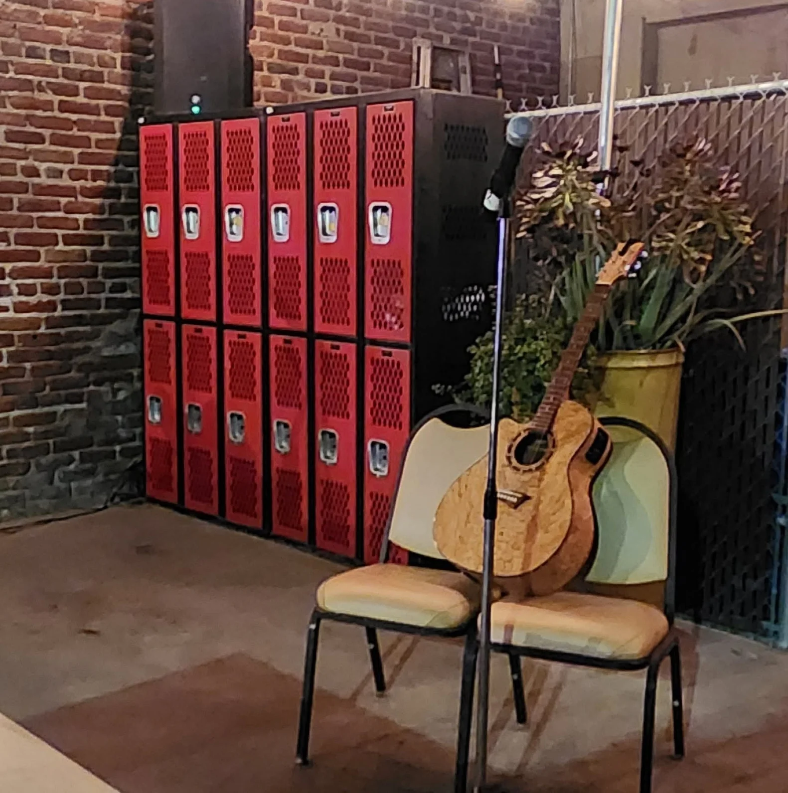 Cozy restaurant stage with acoustic guitar and vintage lockers