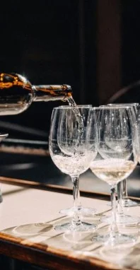 Pouring wine into elegant glasses at a bar