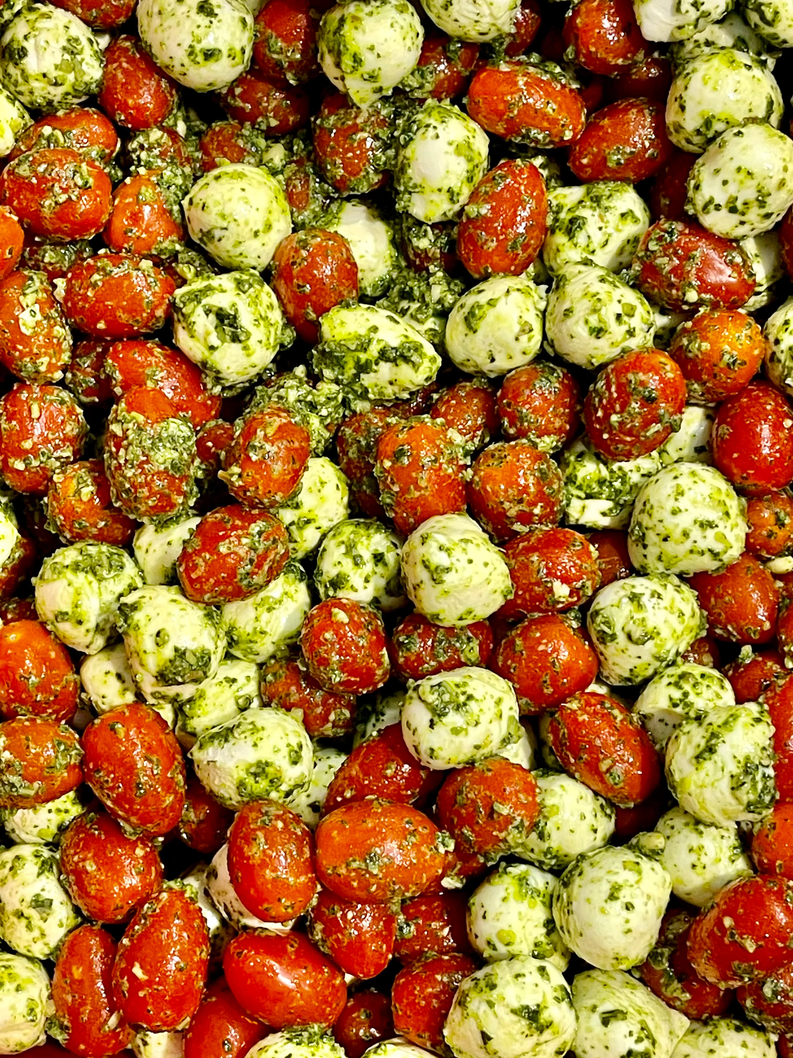Pesto marinated cherry tomatoes and mozzarella balls