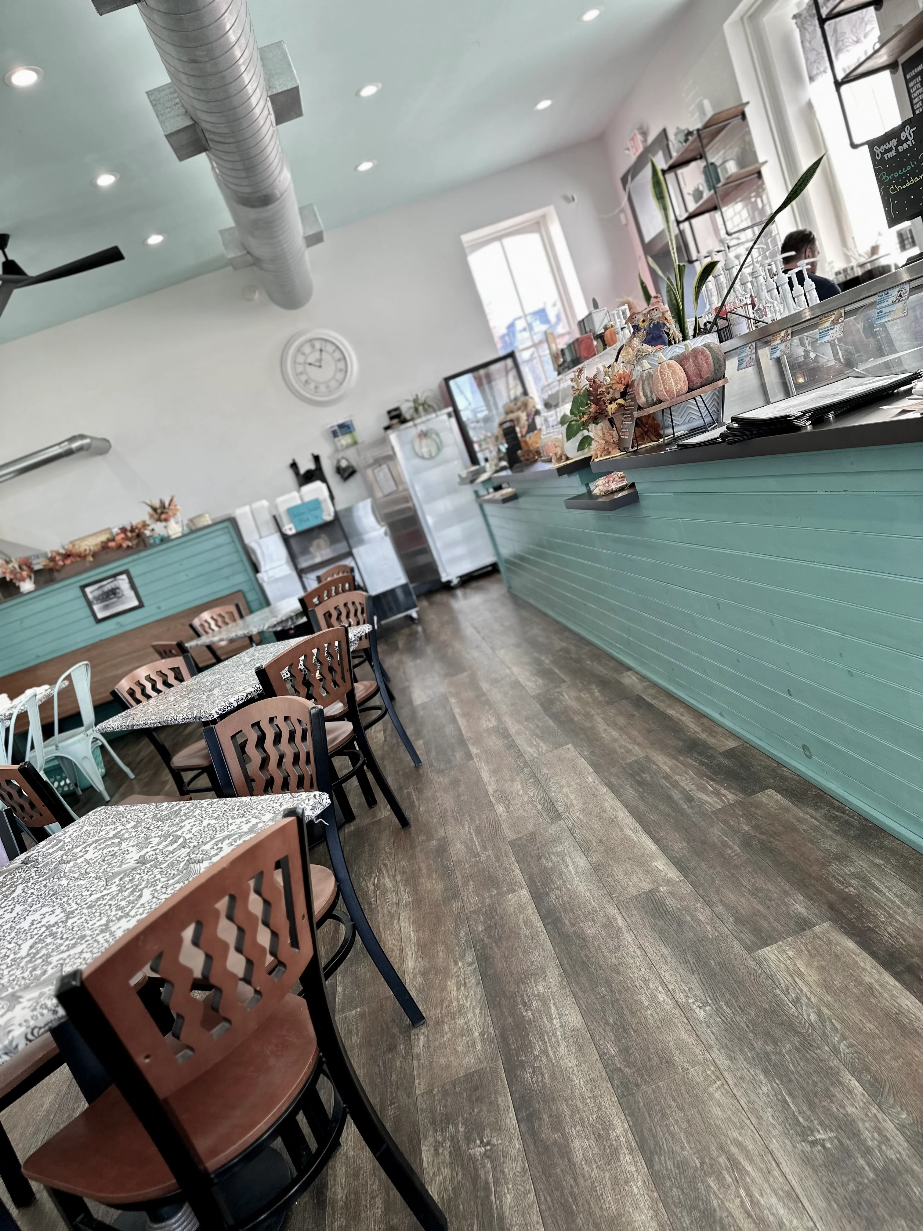 Cozy restaurant interior with teal accents and wooden flooring