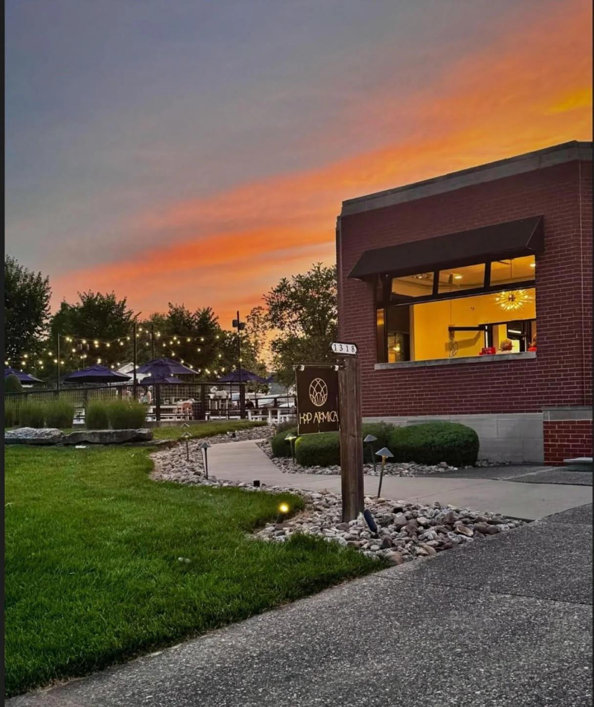 Charming restaurant exterior at sunset with outdoor seating