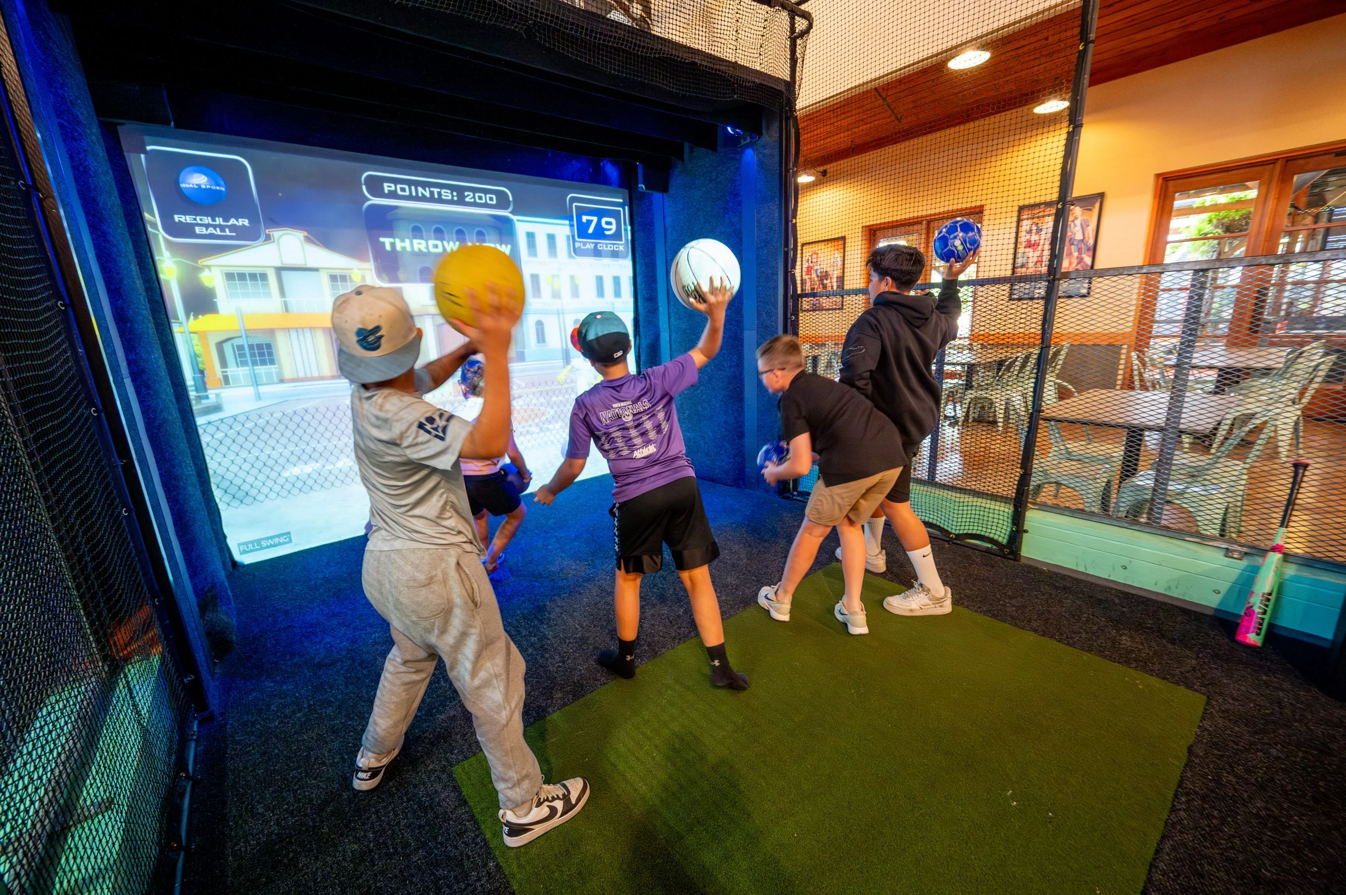 kids throwing balls in an arcade
