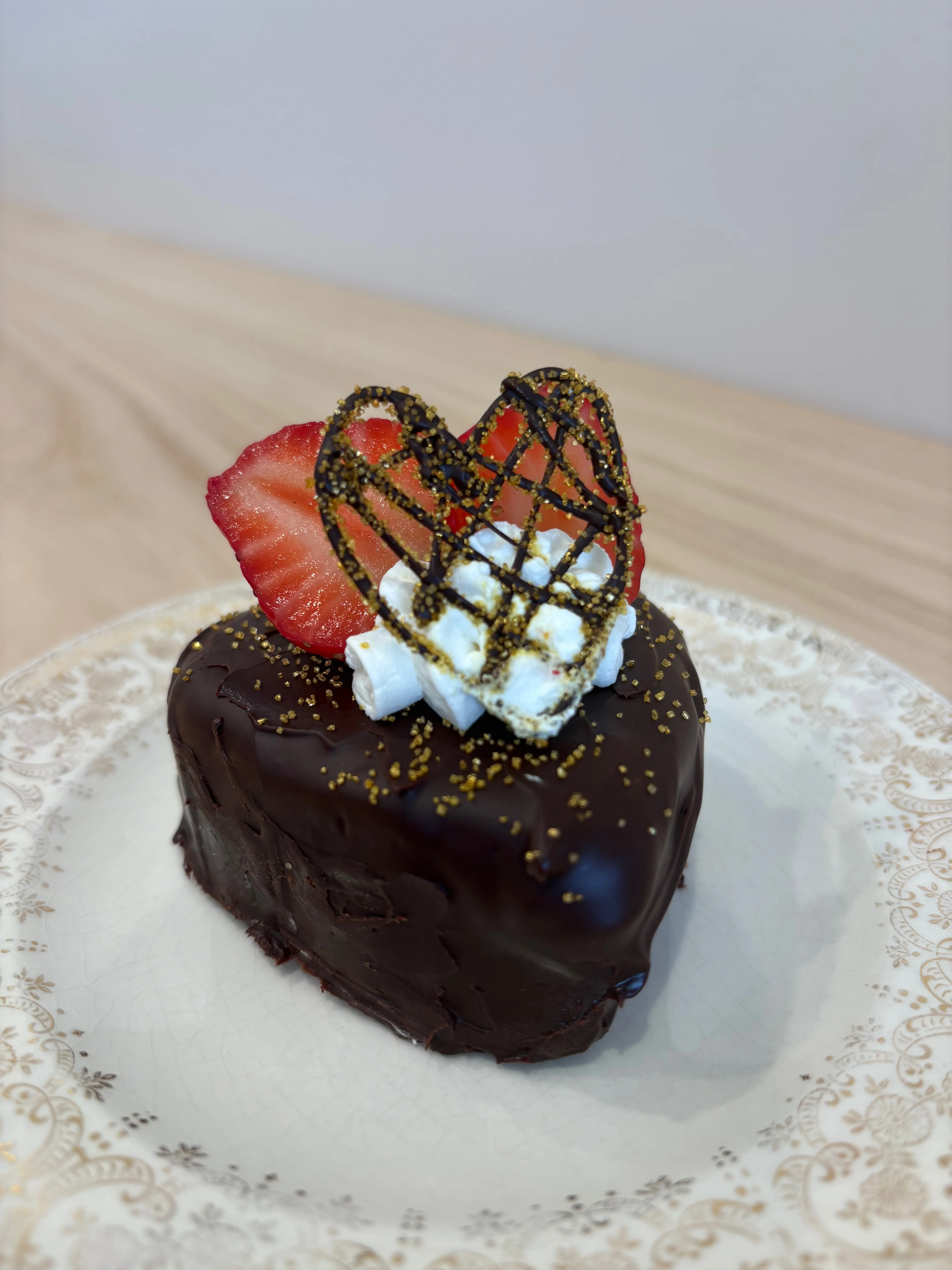Decadent chocolate heart cake with strawberry garnish